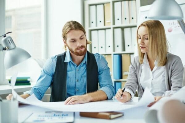 Male and female managers creating a Power Interest Matrix