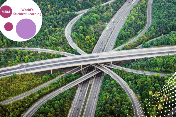 A multi-level highway with green trees