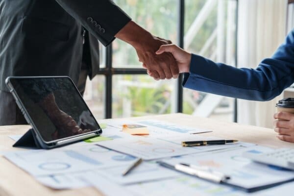 Business people shaking hands after negotiation with ZOPA