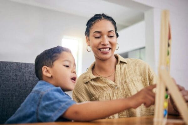 Female manager teaching abacus to a child