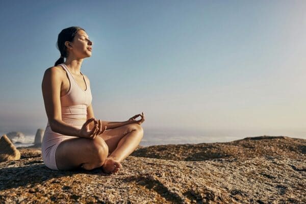 Woman practicing yoga with legs crossed for wellness