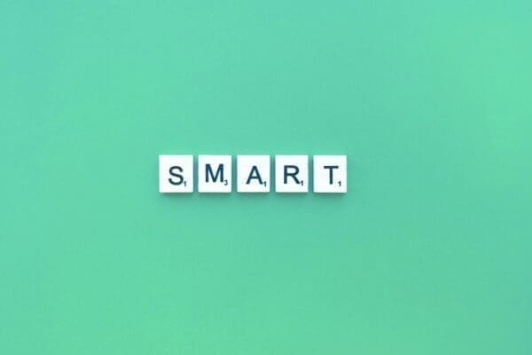 Smart spelled with white cubes on green background