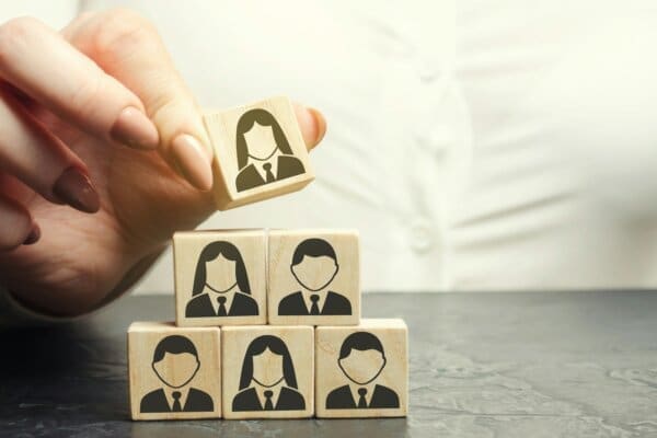 Hand of female manager organising people cubes