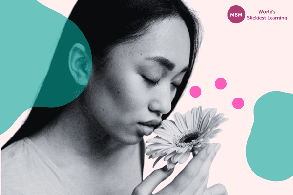 Woman smelling a flower for her well-being