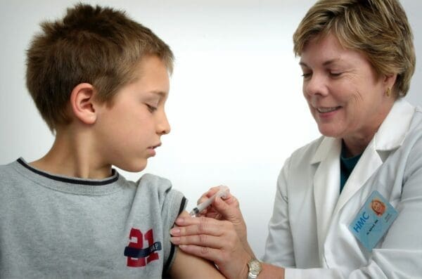 Nurse injecting a young boy